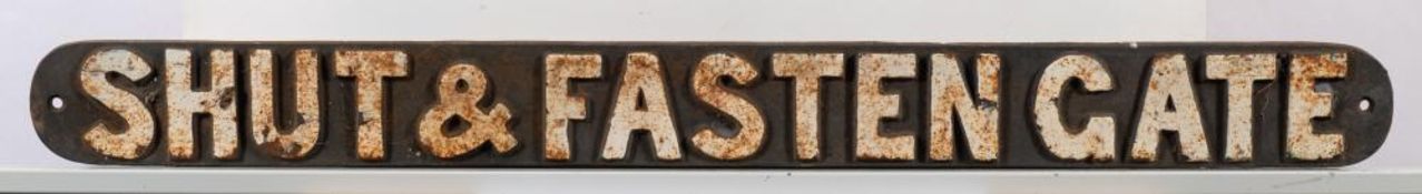 A cast iron sign 'Shut & Fasten Gate': white raised text, 7.5 x 80.