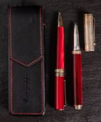 A Montegrappa 1912 roller ball and ball point pen: in red marbled finish with silver mounts,