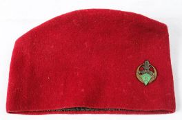 A WWII period 6th Regiment De Tiraillieurs Algerians red cloth fez with enamel regimental badge:.