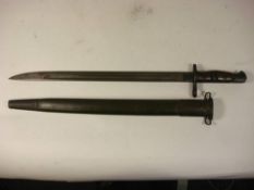 A US Model 1917 bayonet by Remington: the straight blade stamped as per title over two piece wooden