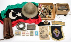 A collection of various militaria: including cap badges and shoulder badges,