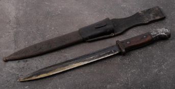 A WWII period German S84/98 bayonet: straight single edge fuller blade over steel hilt and two