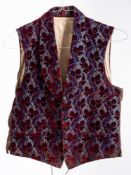 An Edwardian blue silk and maroon cut moquette waistcoat: with three pockets.