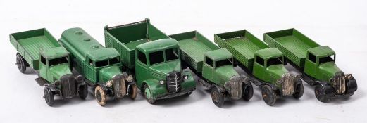 A group of four early Dinky flatbed lorries: together with a pre-war petrol wagon and a 1950's