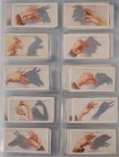 An album of F & J Smith and Taddy Cigarette cards: parts sets including 'Shadowgraphs',