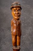 A 19th century Folk Art walking cane of a man in hat: inset glass eyes and standing full length in