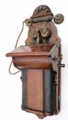 A late 19th/early 20th century Electrisk Bureau double cell brass and mahogany wall mounted