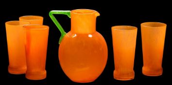 A glass lemonade set: comprising a bright orange jug with applied apple green handle and five