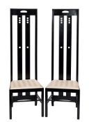 A pair of Rennie Mackintosh style high back ebonised side chairs,: with drop-in seats, each 150.