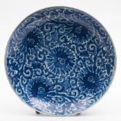 A Chinese blue and white 'Lotus' charger: painted overall with five lotus flowers amongst formal