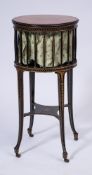 A 19th Century ebonised and gilt decorated circular work table:,