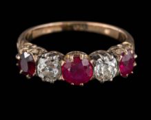 A ruby and diamond five-stone ring: set with round old brilliant-cut diamonds and round and oval