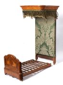 An apprentice's satinwood half tester bed: the canopy with moulded cornice and green silk fringe