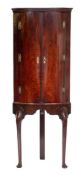 A mid 18th Century mahogany bow-fronted corner cupboard:, on a later stand,