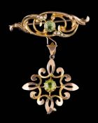 A 15ct gold, peridot and seed pearl mounted bar brooch: suspending a '9ct' stamped peridot,
