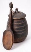 A West African carved wooden food container and cover: of ovoid outline with ring turned banded