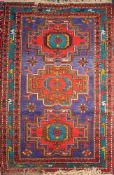 An Azerbaijan rug:, the blue field with three stepped cruciform medallions with flowerhead centres,