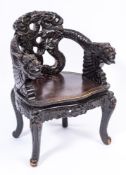 A Chinese carved and ebonised wood armchair:,
