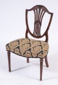 A George III carved mahogany dining chair in the Hepplewhite taste:,