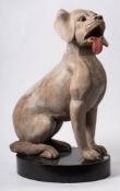 A carved wood and polychrome model of a seated dog 'Biscuit': with inset glass eyes,