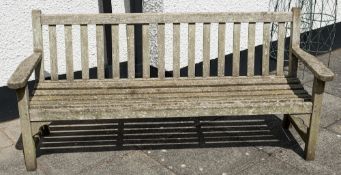 A weathered teak lath garden bench:, 188cm (6ft 2in) long.