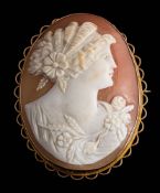 An oval shell cameo portrait brooch: depicting the goddess of Spring within a gold frame,