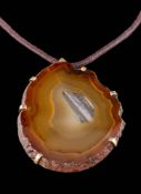 An agate mounted pendant: within a six-claw mount, the suspension loop stamped '9ct',