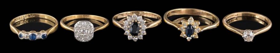 An 18ct gold and diamond nine-stone cluster ring,: a diamond solitaire ring,