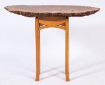 A contemporary side table formed from a section of burr-figured oak:,