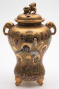 A Satsuma jar and cover: of inverted gourd shaped form with elephant mask handles and set on three