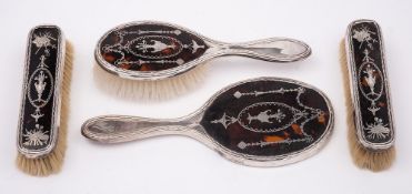 An Edward VII silver and tortoiseshell four piece dressing table set, maker William Comyns, London,