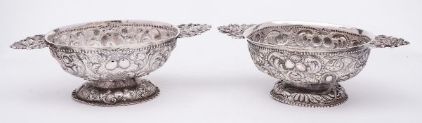 A matched pair of Continental possibly Dutch silver pedestal sweetmeat bowls: of oval outline,