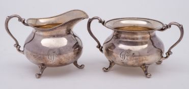 A Sterling silver sugar basin and matching cream jug,