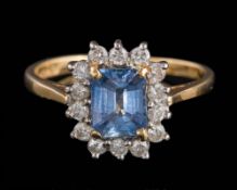 An 18ct gold, sapphire and diamond rectangular cluster ring: the sapphire approximately 6.