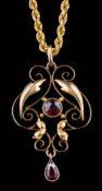 An Edwardian garnet-set cartouche pendant on a 9ct gold necklace: with bolt ring clasp: