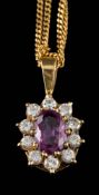 An 18ct gold, pink sapphire and diamond pendant: the oval pink sapphire within a surround of round,