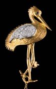 An 18ct gold 'stork' brooch: set with round, brilliant-cut diamonds and blue sapphire-set eye,