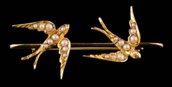 A seed pearl mounted swallow motif bar brooch: approximately 41mm long overall, un-marked.