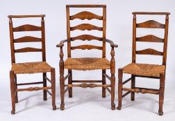 A harlequin set of eight early 19th Century oak, elm, ash and fruitwood ladderback dining chairs:,