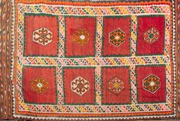 A Kelim flatweave:, the field with eight brick red panels with hexagonal medallions,