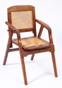 Campaign Furniture A late 19th/early 20th Century hardwood folding armchair:,