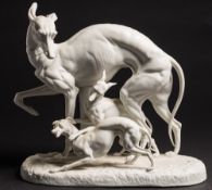 A Continental glazed parian group: of a greyhound playing with her two pups,