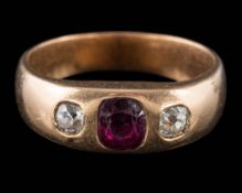 A garnet and diamond three-stone ring: the central,