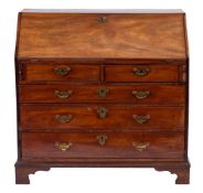 A George III mahogany bureau:, the sloping hinged fall enclosing a fitted interior,