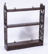 A 19th Century mahogany fret carved three tier hanging bookcase:,