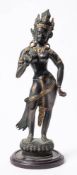 A Nepalese bronze and gilt decorated figure of a female deity: the semi naked female standing on a