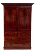 A Victorian mahogany linen press:, the upper part with a moulded cornice, fitted with sliding trays,