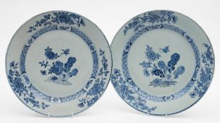 A pair of Chinese blue and white dishes: each painted with peonies and a large butterfly within a