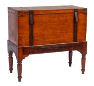 A 19th Century teak and brass banded and mounted trunk on a stained beech stand:,