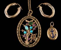 A multi gem set pendant of pierced design and stamped '14K' on an '18K' stamped chain,